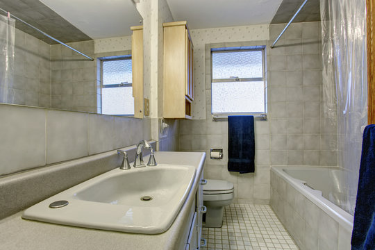 Simple bathroom with tile floors and window.