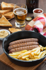 grilled sausages with French fries and toast for lunch