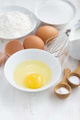ingredients for baking on a white wooden table, vertical