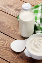 Sour cream in a bowl and milk bottle