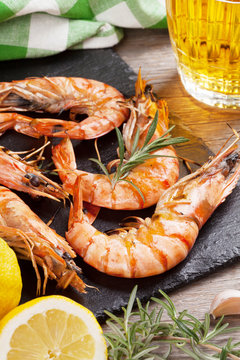 Grilled shrimps on stone plate and beer mug