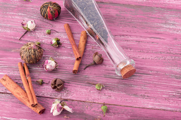 dry tea leaves cinnamon and on wooden background