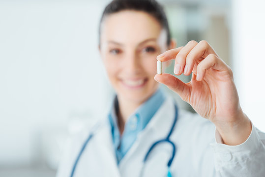 Pharmacist Holding A Pill