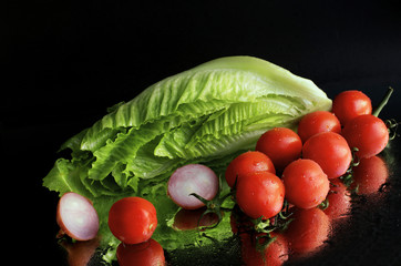 Chinese cabbage with tomatoes on black  background