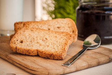 breakfast with sour cherry marmalade on toast with a glass of milk and frutis