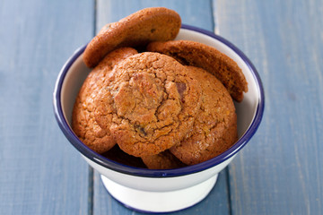 cookies in bowl on blue wooden background
