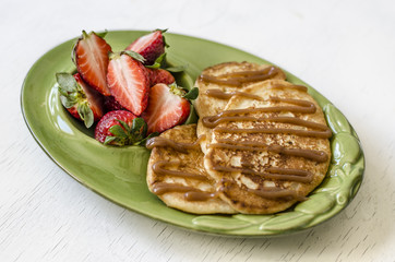 Pancakes with strawberries and caramel sauce 