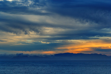 Naklejka na ściany i meble sunset over the sea with a storm approaching