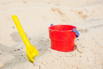 Fototapeta na wymiar Red bucket and yellow spade