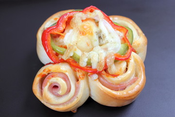  Pizza rolls with vegetables, ham and cheese.