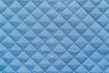 blue quilted synthetic fabric with grained texture