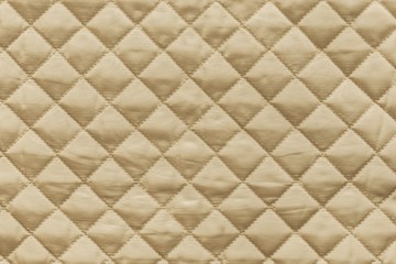 golden quilted fabric with grained texture