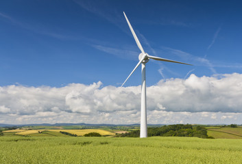A single win turbine sits above a Cornish town. A site on the increase in the English coutryside.