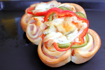 Pizza rolls with vegetables, ham and cheese.