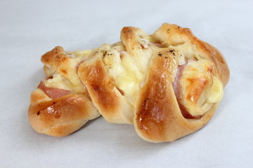 Pizza rolls with vegetables, ham and cheese.