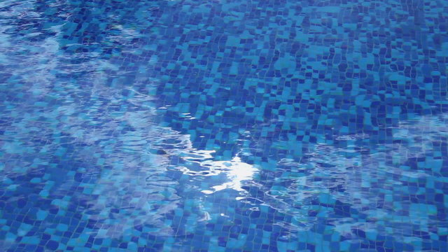 Sun reflection sparkle, blue water surface, hotel swimming pool