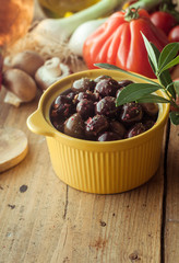 Dish of Olives on Table with Fresh Vegetables