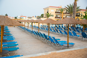 Empty sun beds at hotel swimming pool