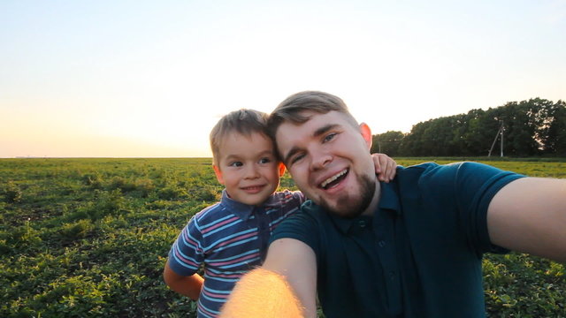 Father and son spending time together in sunny nature, taking