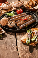 Grilled Sausage and Vegetables on Wooden Table