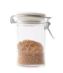 Glass jar filled with mustard seeds isolated