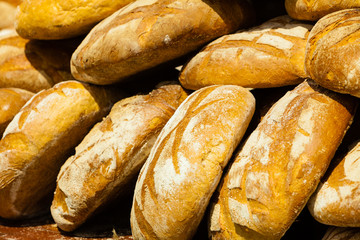 many brown rustic fresh rye bread loaves