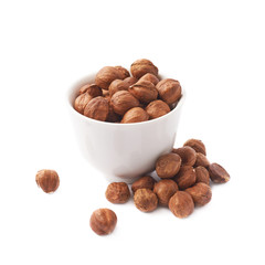 Cup filled with the hazelnuts isolated
