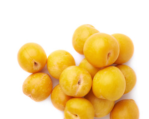 Pile of multiple yellow plums isolated