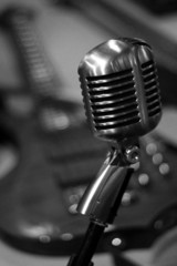 Retro Microphone with Guitar in Background Black and White