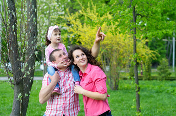 Naklejka na ściany i meble happy family plays a parka with a child