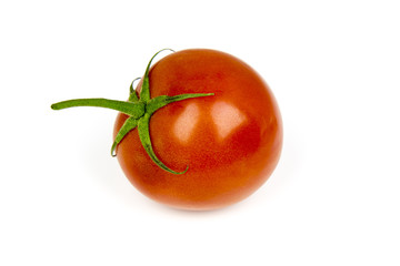 A bright fresh shiny red tomato on a white studio background