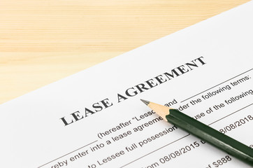 Lease Agreement Contract Document and Pencil at Bottom Right Cor