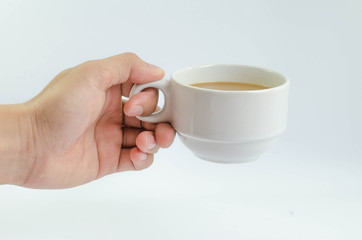 Cup of coffee and laptop on wooden table.