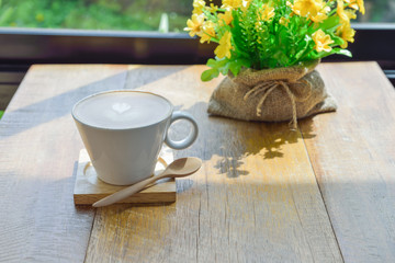 Hot latte coffee in glass  cup mug on wooden table