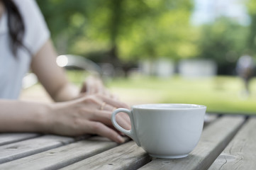 Women are relaxing with a cup of coffee in the garden