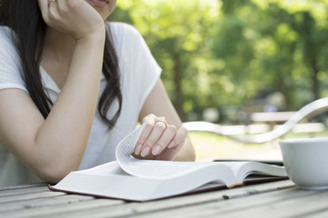 Women have a reading in the park on holiday