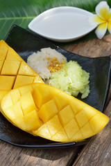 Thai style tropical dessert, glutinous rice eat with mangoes