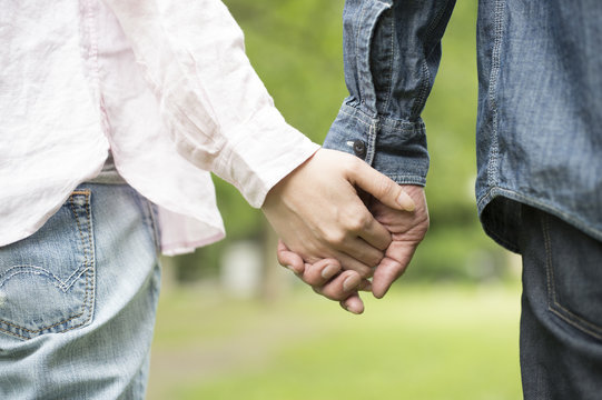 Couple holding hands in the park