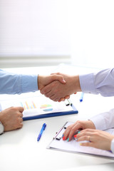 Fototapeta na wymiar Closeup of a business handshake, on white background
