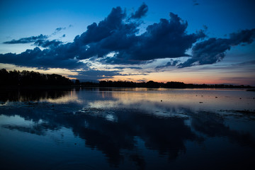 Dramatic clouds after sunset reflecting in the lake