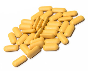 Piles of Yellow Vitamin B tablets isolated