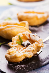 Delicious hot dessert: baked pears in pastry on rustic wooden background. Selective focus