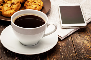 Coffee break with biscuits and newspaper