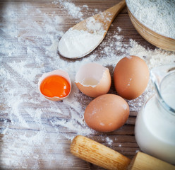 Ingredients for homemade pasta served on a wooden kitchen table