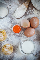 Ingredients for homemade pasta served on a wooden kitchen table