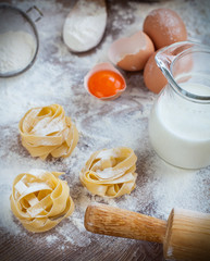 Ingredients for homemade pasta served on a wooden kitchen table