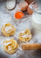 Ingredients for homemade pasta served on a wooden kitchen table