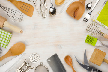 Kitchen utensils and cutlery background with copy space in center