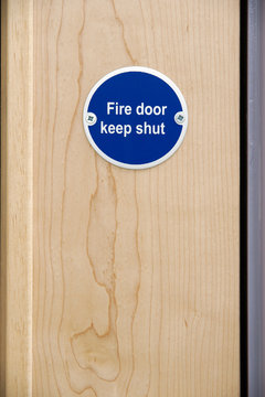 Fire door keep shut sign on an office door