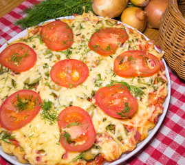 Italian meat pizza with tomatoes and herbs
